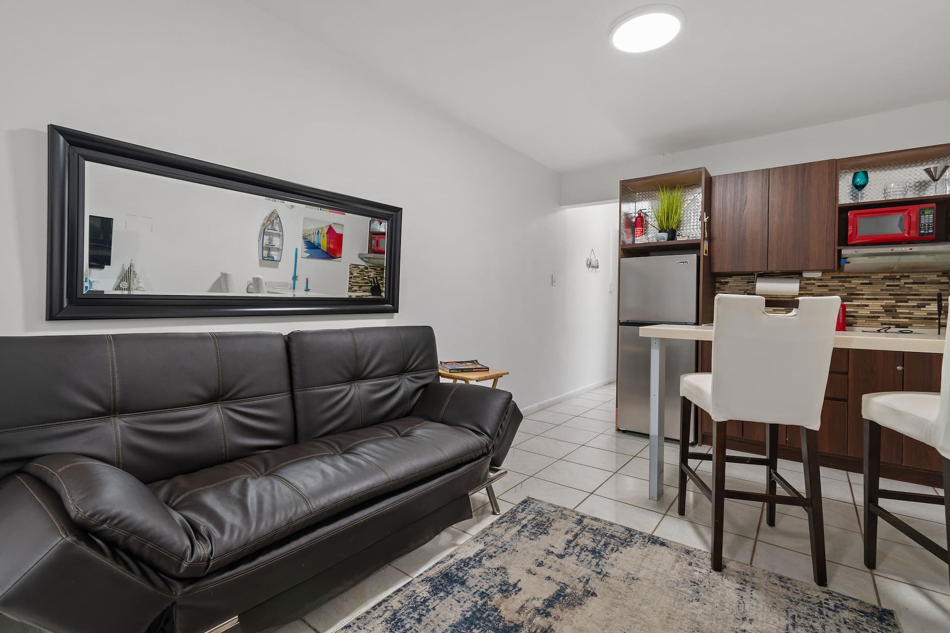 Futon and mirror beside the Marlin kitchenette